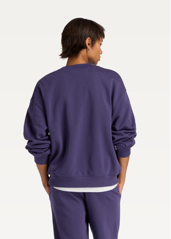 Світшот жіночий New Balance Sport Graphic Oversized Crew фіолетового кольору