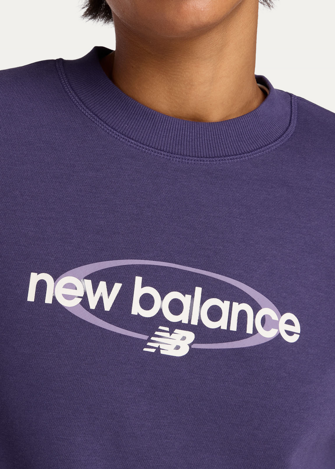 Світшот жіночий New Balance Sport Graphic Oversized Crew фіолетового кольору