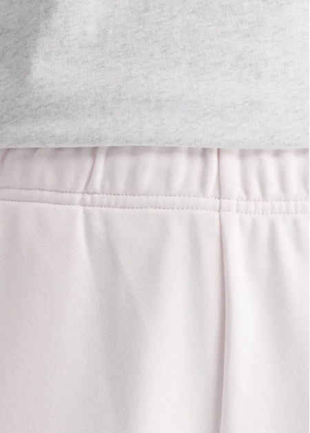 Штани жіночі New Balance Sport Essentials French Terry Jogger світло-рожевого кольору