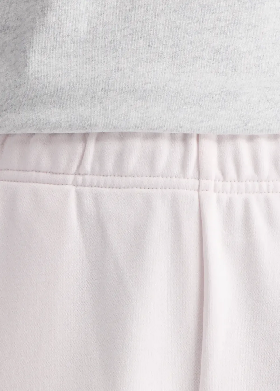 Штани жіночі New Balance Sport Essentials French Terry Jogger світло-рожевого кольору