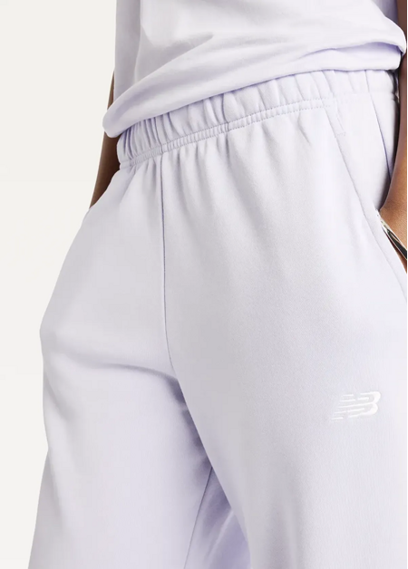 Штани жіночі New Balance Sport Essentials French Terry Jogger бузкового кольору