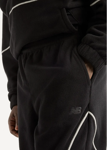 Штани чоловічі New Balance Trackside Polar Fleece чорного кольору