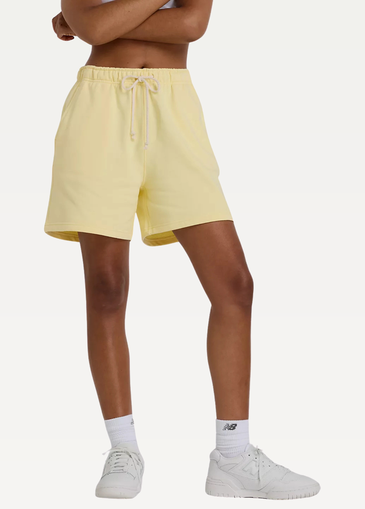 Шорты женские New Balance Athletics FT желтого цвета