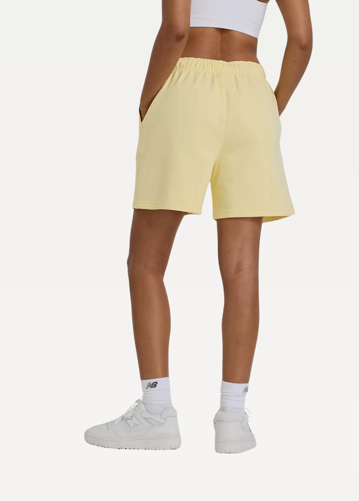 Шорты женские New Balance Athletics FT желтого цвета